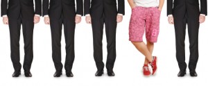 Line of men in suits and one in shorts