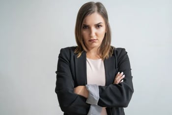 Woman with arms crossed not smiling
