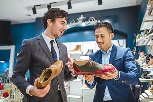 Salesman showing man shoes