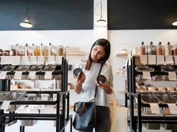 woman in store comparing two products