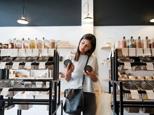 woman in store comparing two products