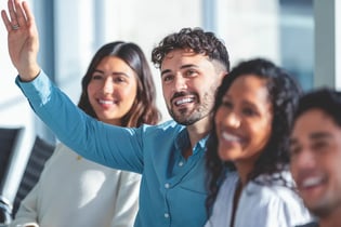 man raising hand with question