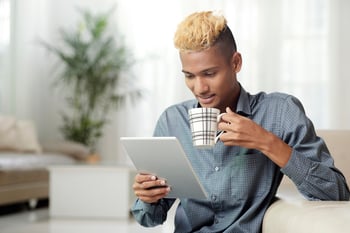 man reading tablet article