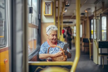 Woman using social media on her phone on a bus