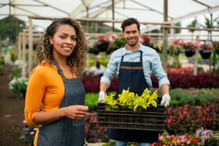 Manager training employee in garden store