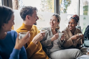 Group of millennials drinking coffee and chatting