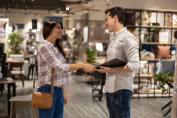 salesman shaking hands with customer