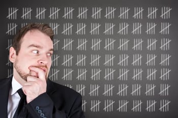 man looking sideways at tally marks
