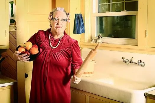 Angry woman brandishing rolling pin