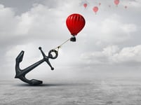 balloon held back by giant anchor