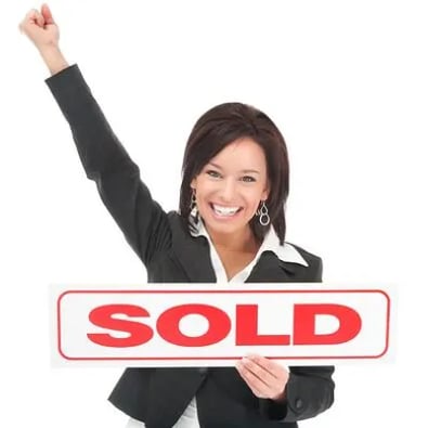 Realtor holding Sold sign