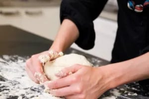 Hands kneading dough