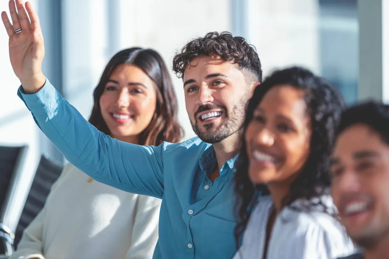 man raising hand with question